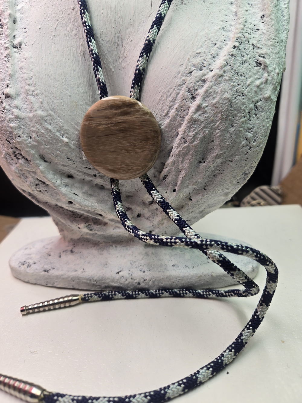bolo tie featuring a polished, oval-shaped cabochon In A Navyblue/grey Cord